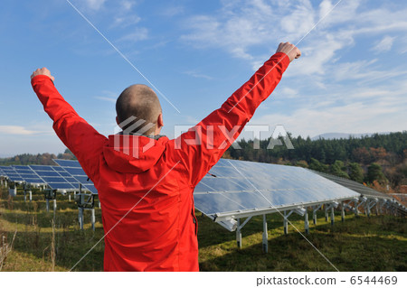 Male solar panel engineer at work place Male solar panel engineer at work place 6544469