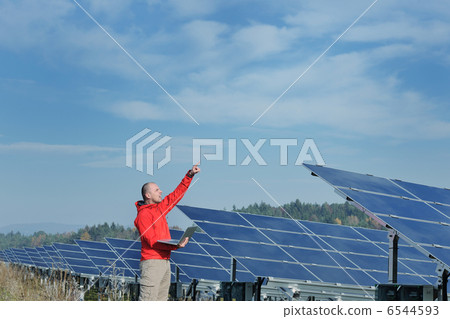 engineer using laptop at solar panels plant field engineer using laptop at solar panels plant field 6544593