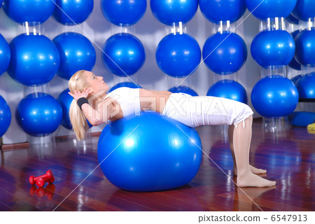 young woman exercising with pilates ball young woman exercising with pilates ball 6547913