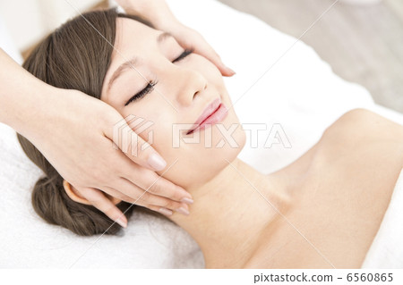 A woman receiving facial beauty treatment A woman receiving facial beauty treatment 6560865