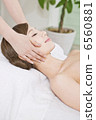 A woman receiving facial beauty treatment 6560881