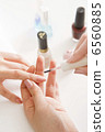Women's wearing nail polish at the nail salon 6560885