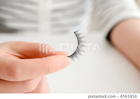 Hand with false eyelashes Hand with false eyelashes 6561958