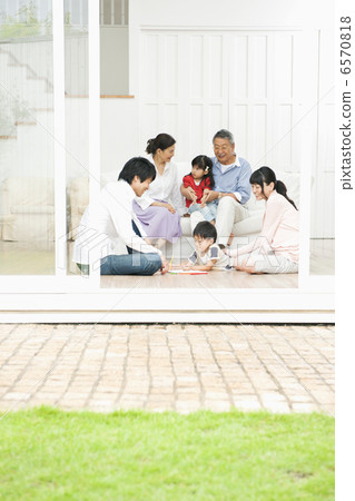Three-generation family relaxing in the living room 6570818