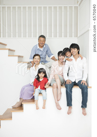 Three generations family sitting on the stairs portrait 6570840