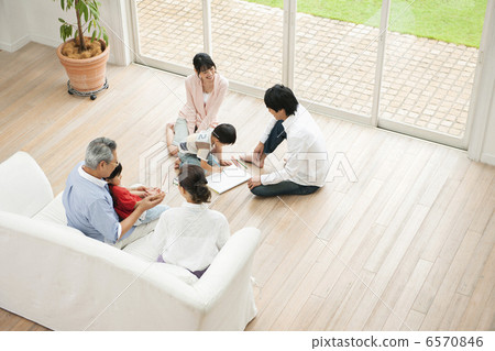 Three-generation family relaxing in the living room Three-generation family relaxing in the living room 6570846