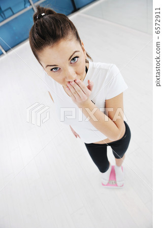 happy diet concept with young woman on pink scale happy diet concept with young woman on pink scale 6572911