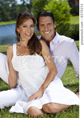 Successful Happy Middle Aged Man and Woman Couple Sitting Outsid Successful Happy Middle Aged Man and Woman Couple Sitting Outsid 6579153
