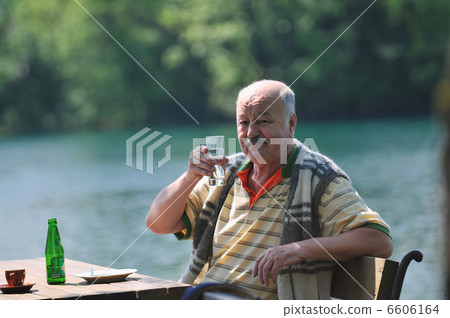 senior man eat desser at outdoor restaurant senior man eat desser at outdoor restaurant 6606164