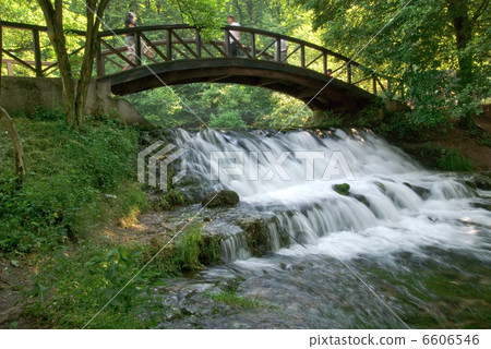 wooden bring over small waterfall 6606546