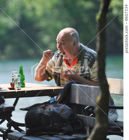 senior man eat desser at outdoor restaurant senior man eat desser at outdoor restaurant 6607334