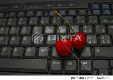 fresh cherry on laptop keyboard 6608942