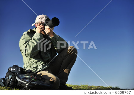 Nature photographer with digital camera Nature photographer with digital camera 6609767