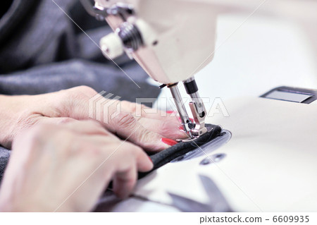 Hands of Seamstress Using Sewing Machine Hands of Seamstress Using Sewing Machine 6609935