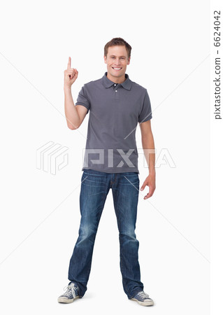 Smiling young man pointing up Smiling young man pointing up 6624042