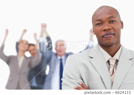 Tradesman with cheering team behind him Tradesman with cheering team behind him 6624115