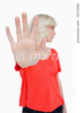 Stop sign made by a young blonde woman 6625000