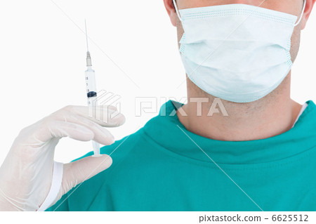 Close up of doctor with syringe wearing scrubs 6625512
