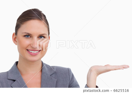 Close up of smiling tradeswoman holding her palm up 6625516