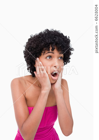 Surprised teenage girl looking to the side while putting her han Surprised teenage girl looking to the side while putting her han 6628004