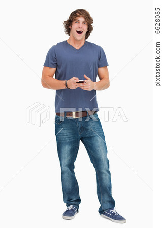 Open-mouthed student holding a cellphone 6628085