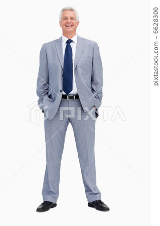 Portrait of a smiling businessman with his hands in his pockets 6628300