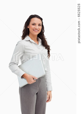 Brunette standing while holding a laptop Brunette standing while holding a laptop 6628828