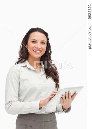 Portrait of a brunette standing while using a touchpad 6628831