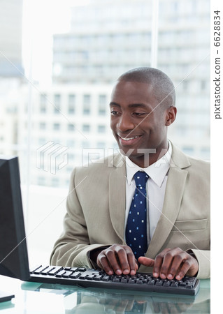 Portrait of an office worker using a computer Portrait of an office worker using a computer 6628834