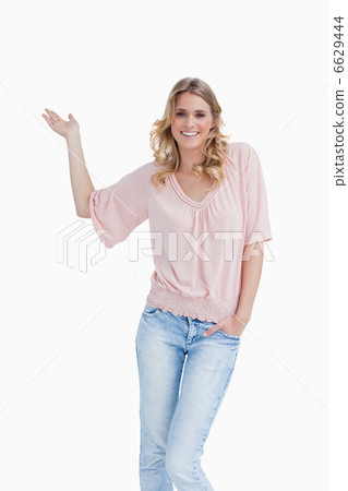 Smiling young woman placing her hand palm up Smiling young woman placing her hand palm up 6629444