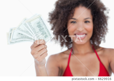 Bank notes being held by an attractive woman 6629916
