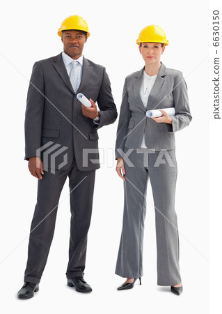 Two serious business people wearing hard hats 6630150