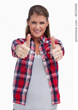 Portrait of a young woman with the thumbs up Portrait of a young woman with the thumbs up 6630898