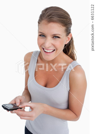 Portrait of a happy woman holding her mobile phone Portrait of a happy woman holding her mobile phone 6631122