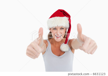Woman with the thumbs up and a Christmas hat Woman with the thumbs up and a Christmas hat 6631123