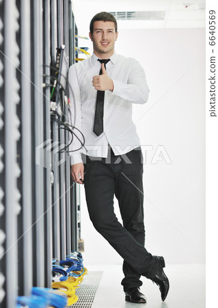 young engeneer in datacenter server room 6640569