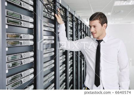 young engeneer in datacenter server room young engeneer in datacenter server room 6640574