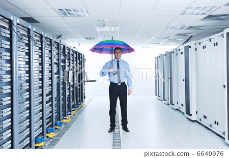 businessman hold umbrella in server room businessman hold umbrella in server room 6640976