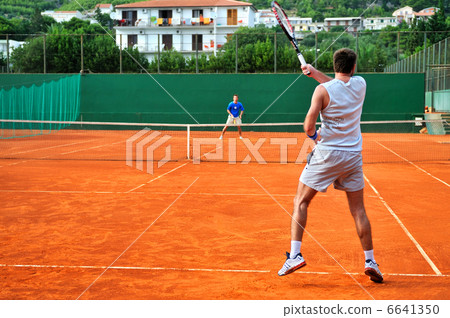 Man plays tennis outdoors Man plays tennis outdoors 6641350