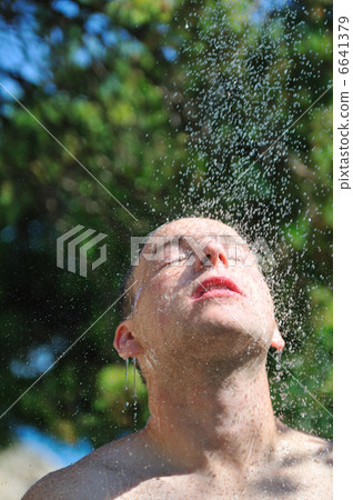 young man relaxing under shower 6641379