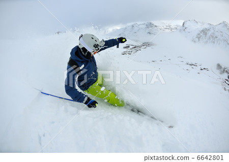 skiing on fresh snow at winter season at beautiful sunny day 6642801