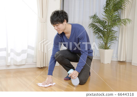 A young man wiping the floor A young man wiping the floor 6644318