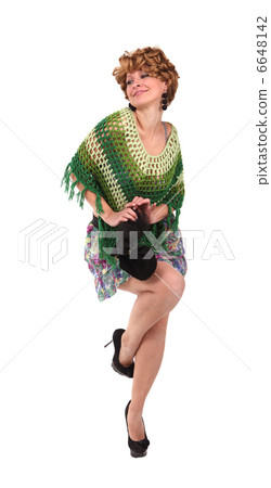 Girl in a green knit poncho on tne white background 6648142