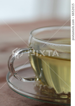 Lemon herbal tea in a heat-resistant glass teacup 6652015