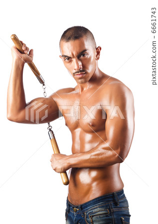 Man in martial arts concept with nunchucks 6661743