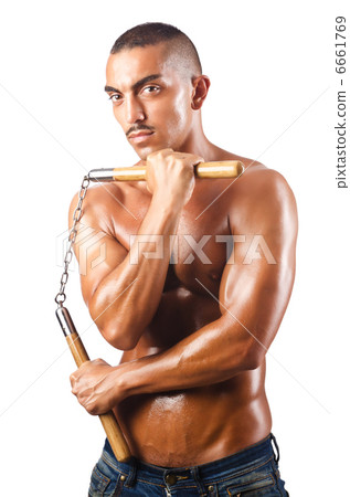 Man in martial arts concept with nunchucks Man in martial arts concept with nunchucks 6661769