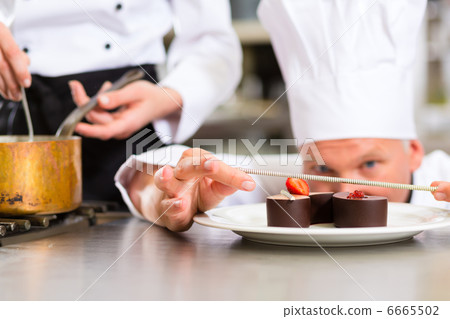 Chef as Patissier cooking in Restaurant dessert 6665502