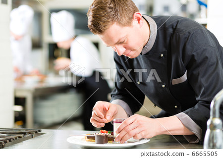 Chef as Patissier cooking in Restaurant dessert 6665505