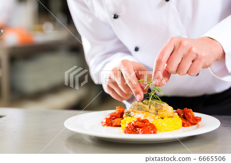 Female Chef in restaurant kitchen cooking 6665506