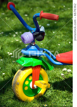 Tricycle in the garden. Tricycle in the garden. 6676362
